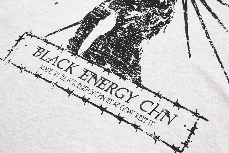 Close-up of front graphic text and distressed black print on light gray tee