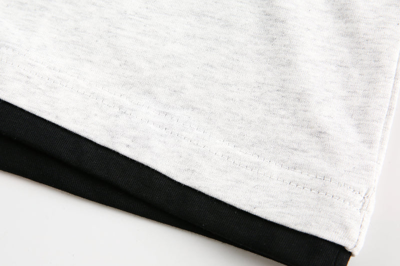 Hem detail showing light gray fabric with black contrast trim