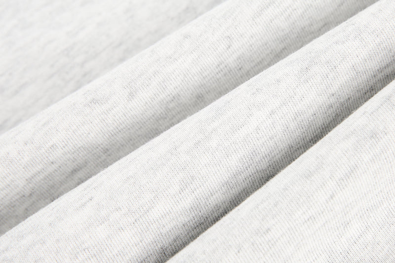 Close-up of light gray knit fabric with soft heathered texture