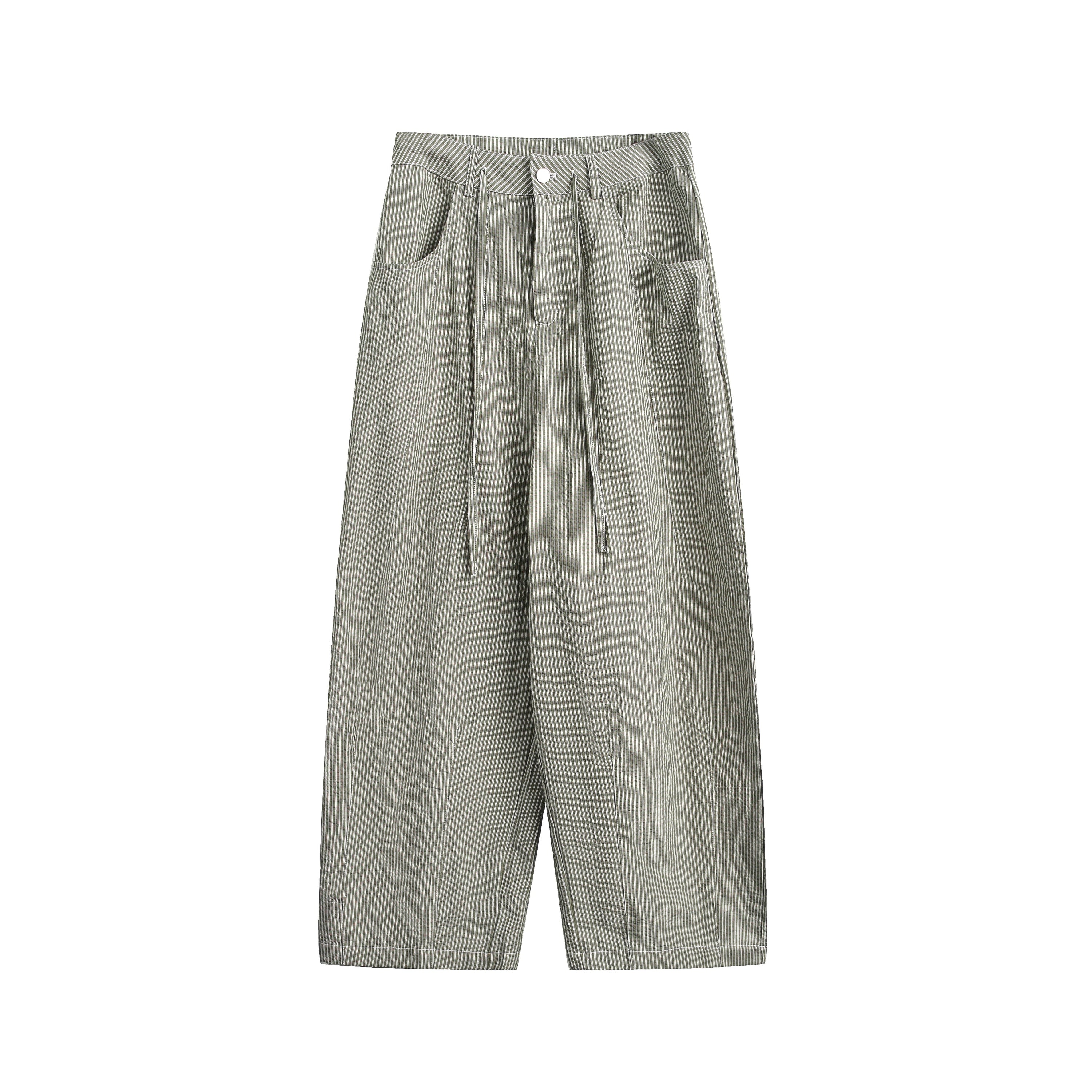 Front view of olive pinstripe wide-leg cotton pants with pleated front, drawstring waist and side pockets