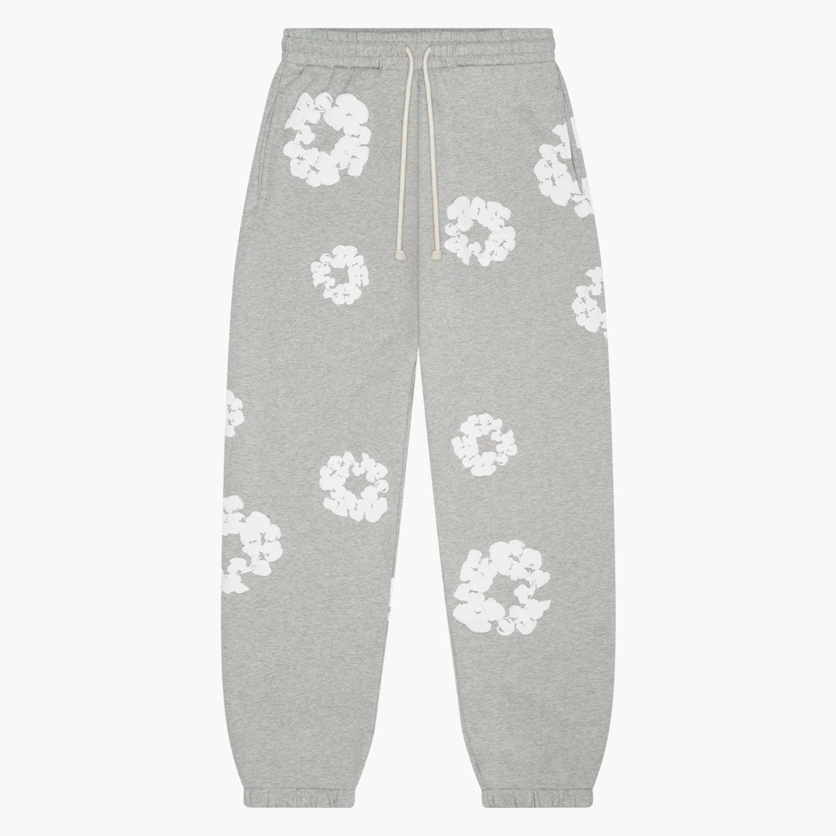 Grey “Cotton Wreath” Denim Tears Sweatpants feature an elastic waistband with a white drawstring, cuffed ankles, and scattered white abstract cotton wreath floral prints for a modern streetwear look.