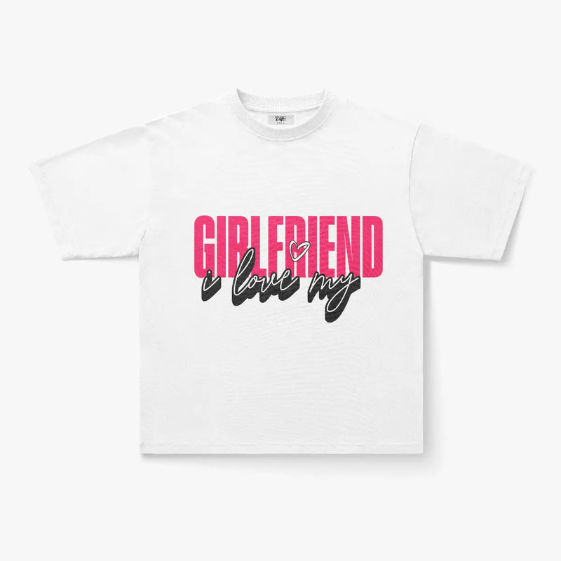 The I Love My Girlfriend Oversized Graphic Print T-Shirt is a comfy heavyweight cotton streetwear tee with bold pink GIRLFRIEND text and black "i love my" script with a heart accent—perfect for stylish everyday wear.