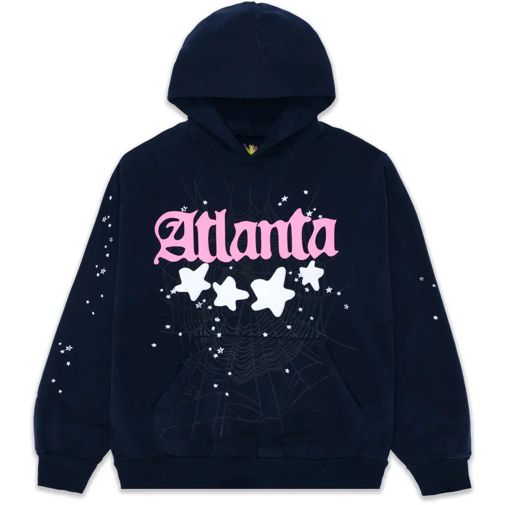 The Sp5der “Atlanta Nights” Web Hoodie is a navy blue 440GSM heavyweight oversized streetwear pullover featuring bold pink Gothic "Atlanta" lettering, white stars, sparkles, sleeve accents, and a subtle front spider web pattern.