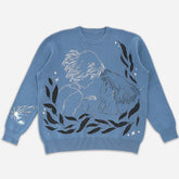 The Seakoff Premium Howl’s Moving Castle-Inspired Knit Sweater features a blue anime-style design of Howl and Sophie embracing, accented by black leaves, white stars, and a small white burst on the left sleeve.