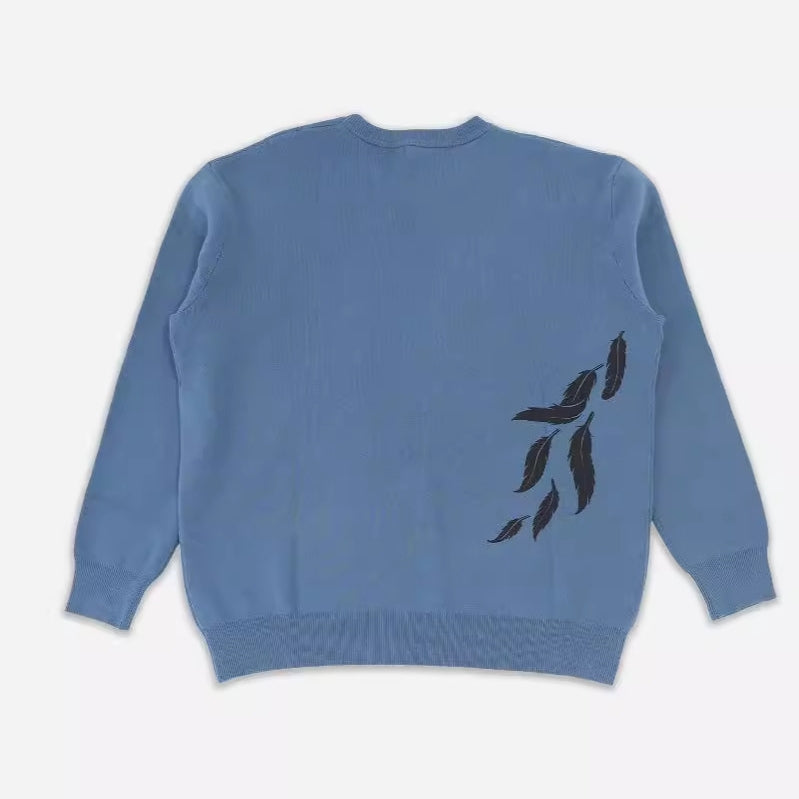 Seakoff's Premium Howl’s Moving Castle-Inspired Knit Sweater features a Howl & Sophie starry jacquard design. Laid flat, it showcases ribbed cuffs, hem, and neckline. Perfect for anime streetwear fans seeking Studio Ghibli-inspired knitwear with subtlety and style.