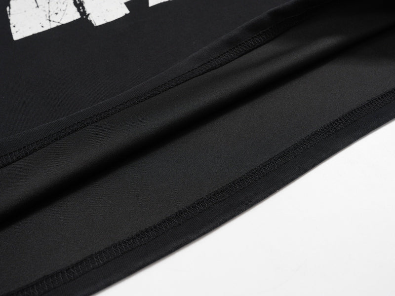 Close-up of black jersey hem with stitching and partial 47 print above