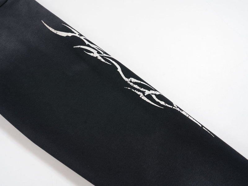 Close-up of black sleeve with white distressed graphic along the outer arm