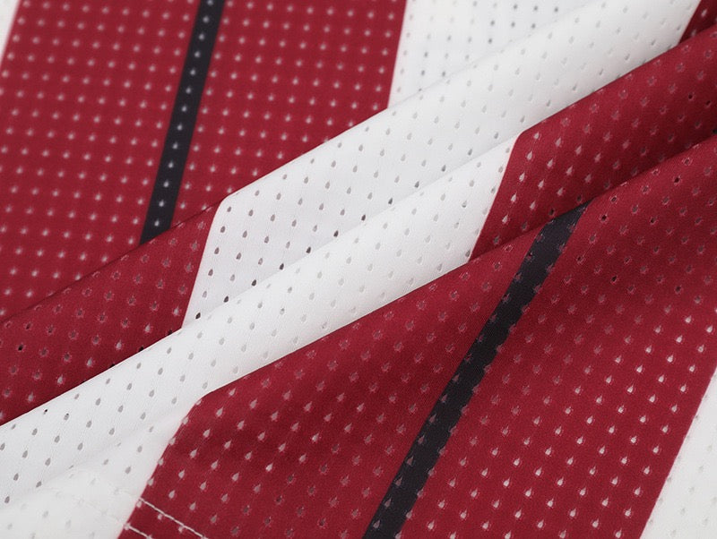 Close-up of red and white striped mesh football jersey fabric with black accent lines, Tideeku No.7 streetwear style