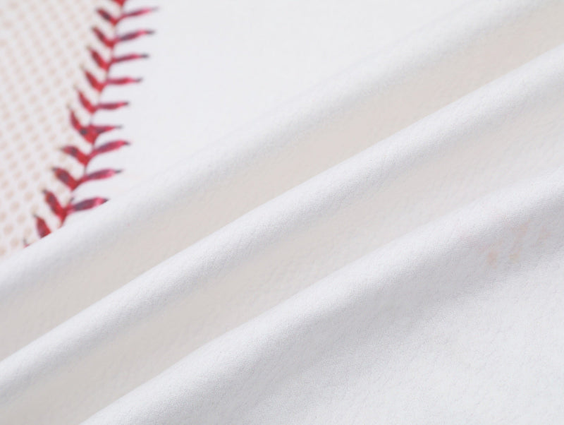 Close-up of white mesh baseball tee fabric with red stitched seam detail and soft retro sport texture