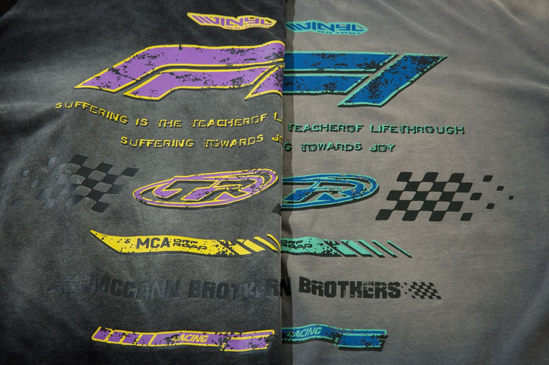 Close-up of overlapping black and gray tee fronts with purple and blue TR graphics