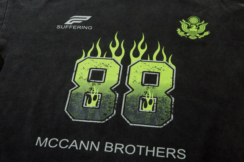 Close-up of black front graphic with neon green flaming 88 and McCann Brothers text