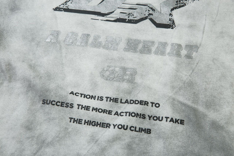 Close-up of gray front print with slogan text and lower graphic on long sleeve tee