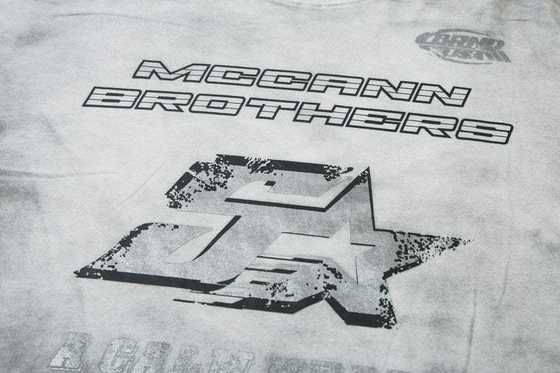 Close-up of gray front logo and large star graphic on layered long sleeve tee
