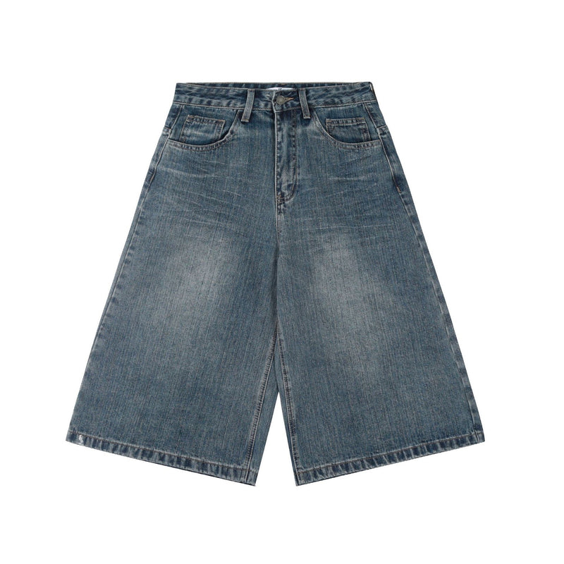 Front view of wide-leg denim shorts in faded blue wash with five-pocket styling