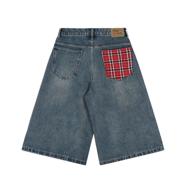 Back view of blue wide-leg denim shorts with red plaid patch pocket