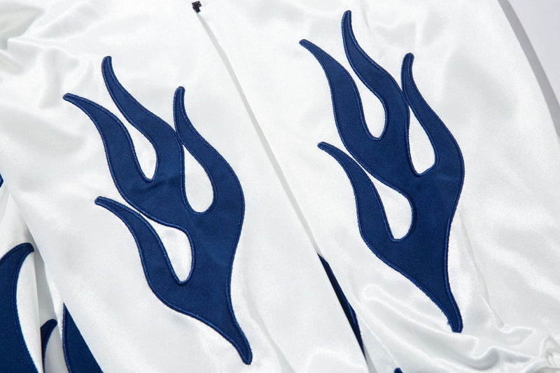 Close-up of white jersey flame graphics in blue on the sleeves and side