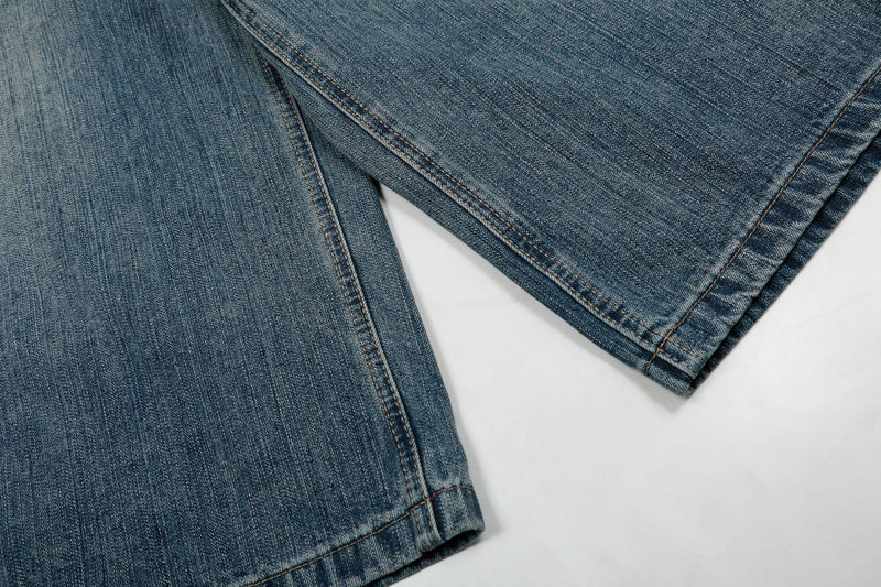 Close-up of denim hem and leg seams on wide-leg shorts