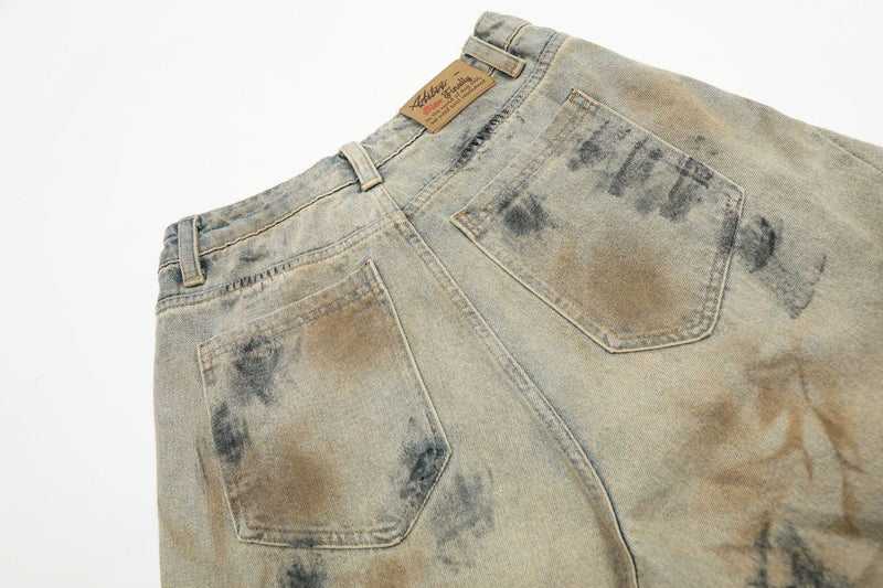 Back waistband and pocket detail of vintage wash denim shorts with spray-dye marks