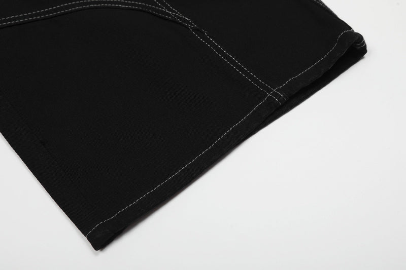 Close-up of black shorts leg hem with contrast topstitching