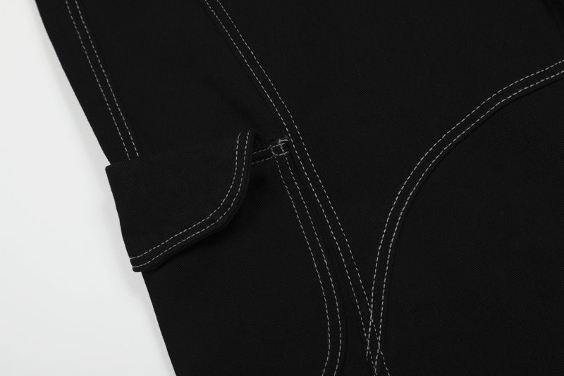 Close-up of black cargo shorts side cargo pocket and curved seam detail