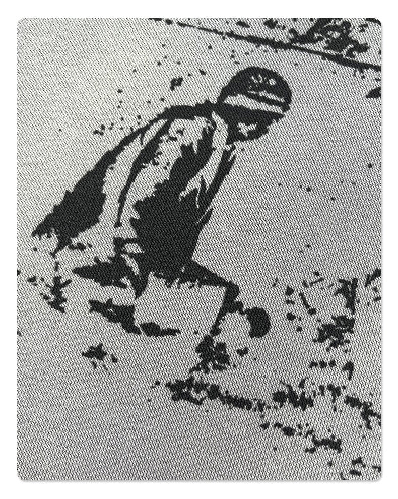 Close-up of printed figure on light gray hoodie fabric