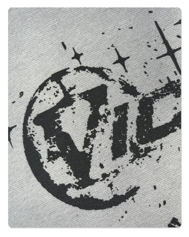 Close-up of distressed Vicinity logo print on light gray hoodie fabric