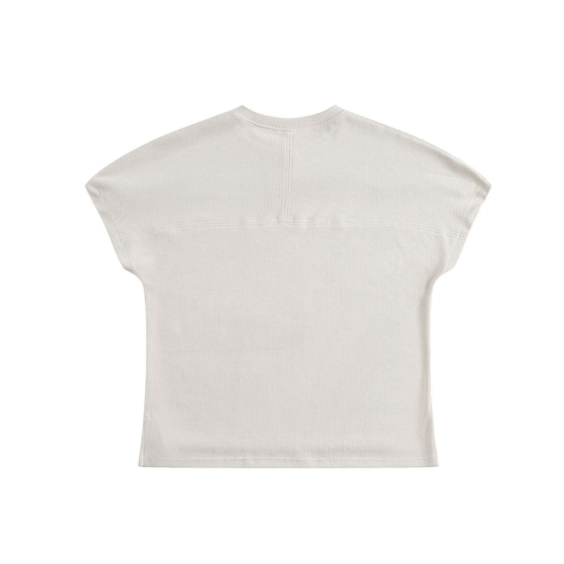 Beige ribbed minimalist tee with layered chest panel and structured short sleeves on a clean white background