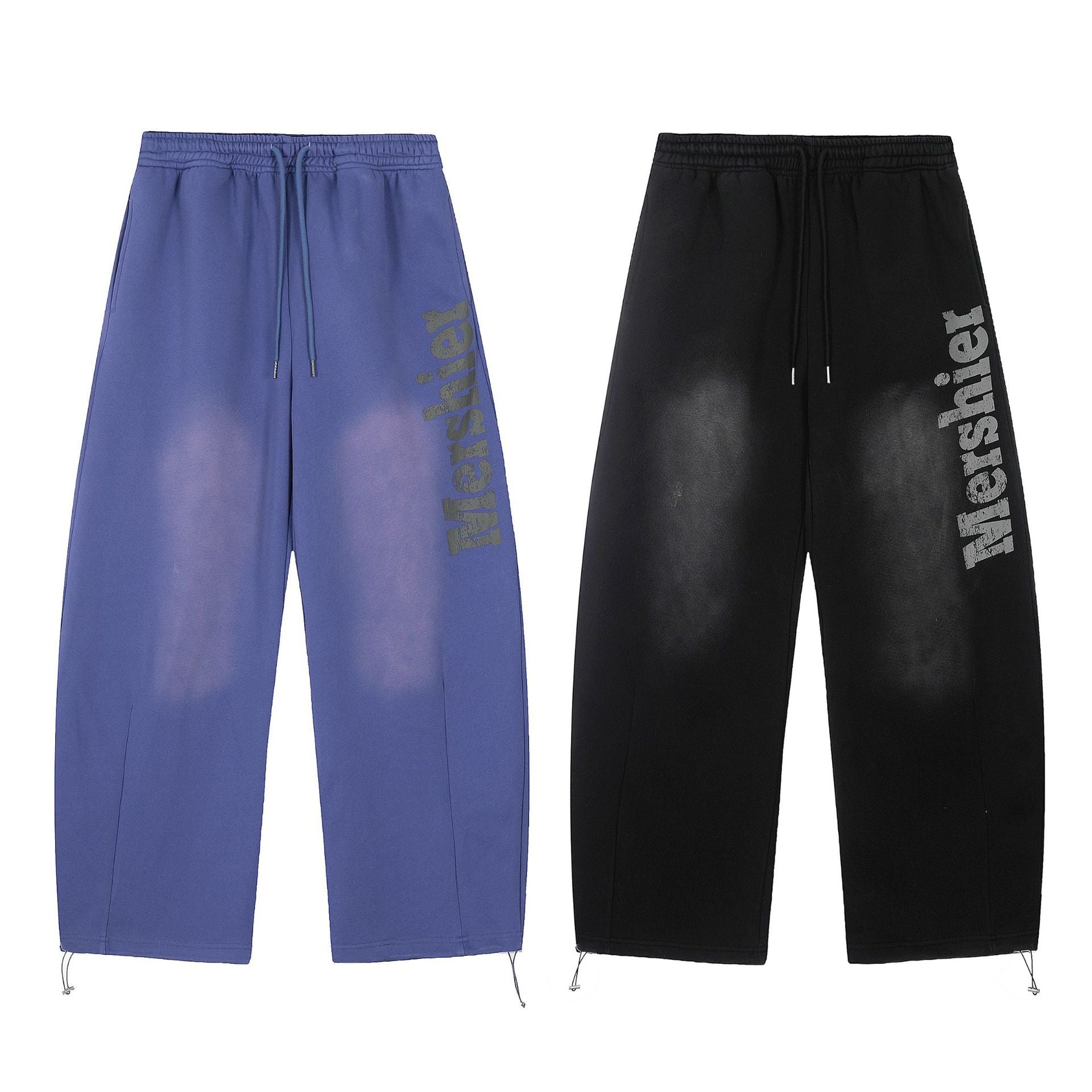 Black wide-leg sweatpants with distressed vertical logo print and sun-faded wash effect, shown flat on white background