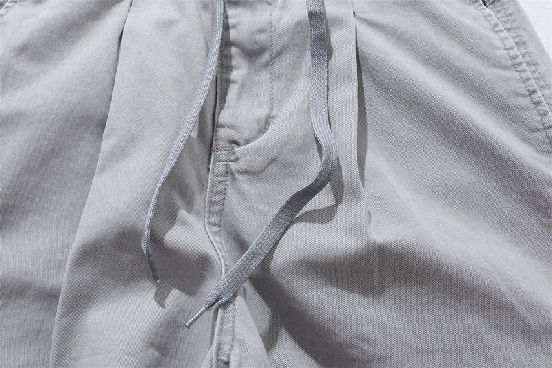 Close-up of light gray drawstring hanging from the front waistband of the shorts