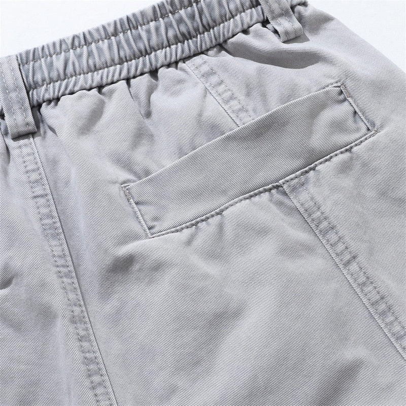Close-up of light gray back pocket and seam detail on relaxed shorts