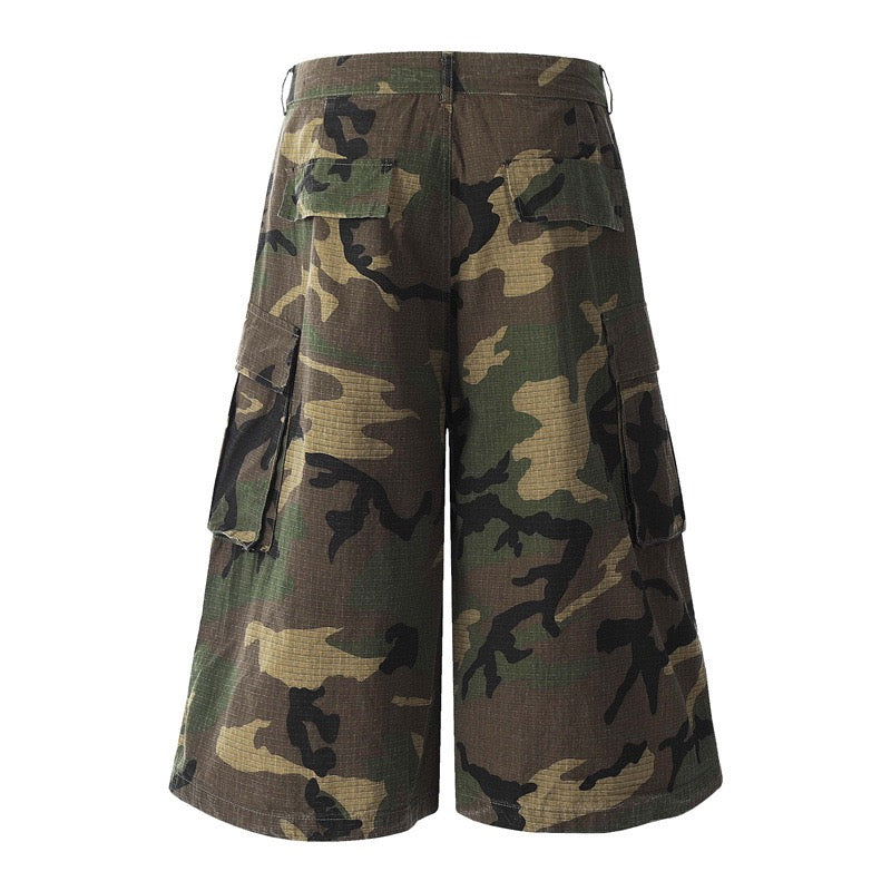 Back view of woodland camo wide-leg cargo shorts with rear flap pockets