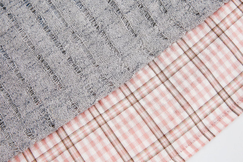 Close-up of a gray mesh graphic tee with a pink plaid collar detail and distressed vintage texture