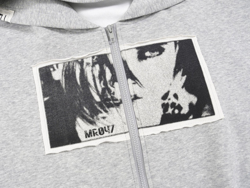 Close-up of the light gray zip hoodie chest showing the black-and-white collage graphic