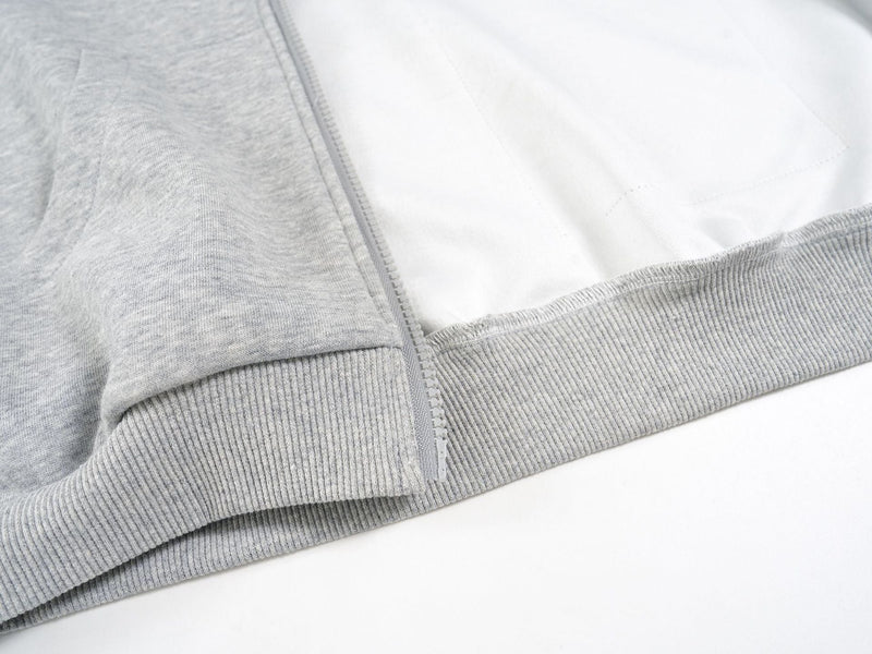 Close-up of the light gray hoodie cuff and inside lining near the zipper