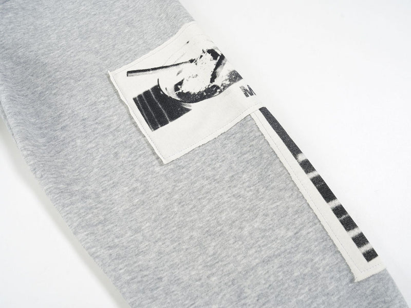 Close-up of the light gray hoodie sleeve graphic patch and side trim