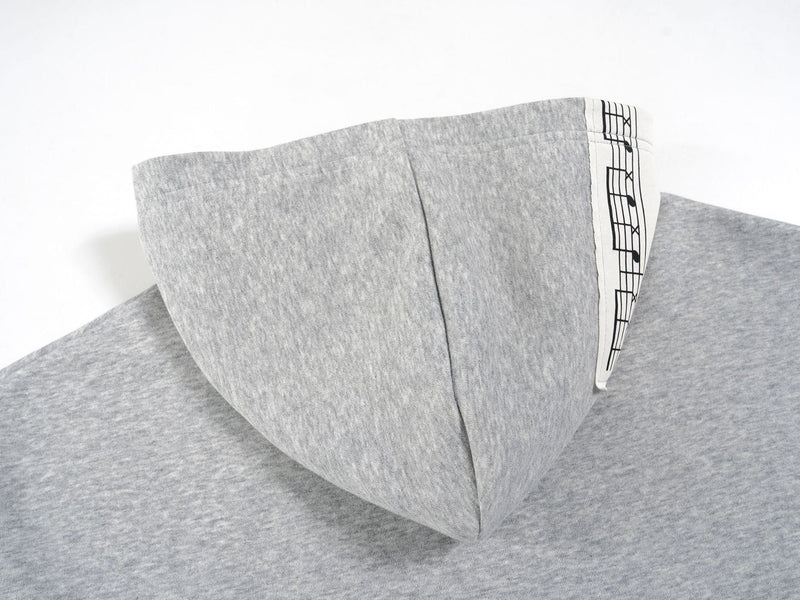Close-up of the light gray hoodie hood from the back with printed trim detail