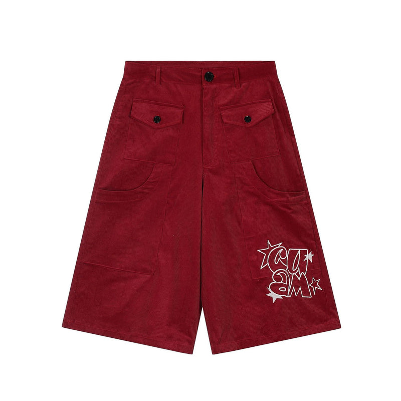 Red corduroy cargo shorts with front flap pockets, black buttons, and star graphic on one leg