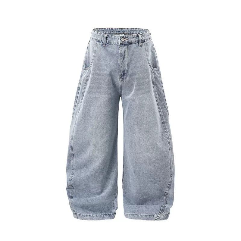 Light blue washed balloon wide-leg denim pants with oversized rounded silhouette and structured seam details, front view