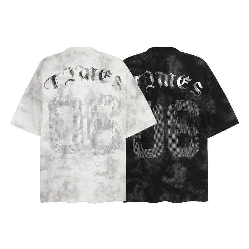 Back view of two oversized marble wash graphic tees in white and black with perforated number print and Old English lettering