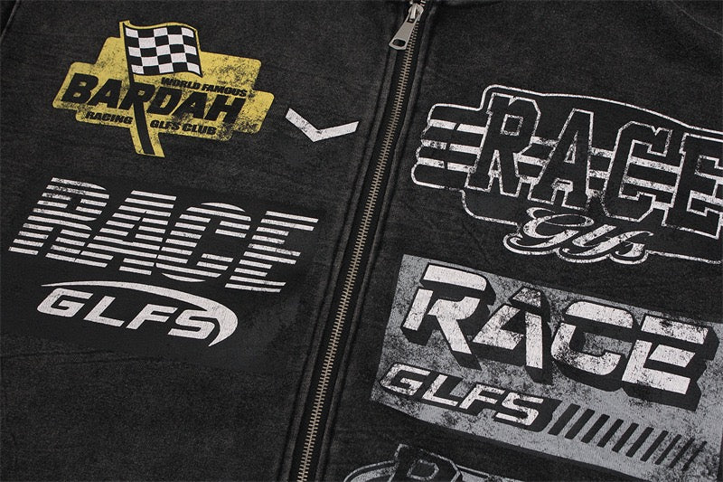 Close-up of black hoodie front with race graphics and center zipper