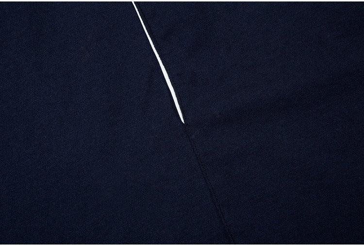 Close-up of a black oversized paneled jersey tee with a subtle white seam detail and streetwear design