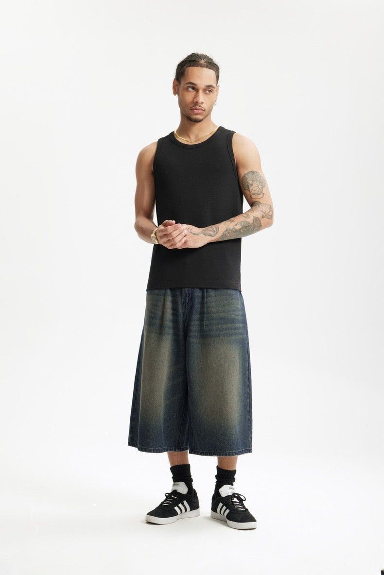 Front-facing studio view of relaxed-fit wide-leg denim shorts on model