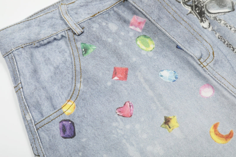 Close-up of front pocket area on light wash denim shorts with colorful gem prints