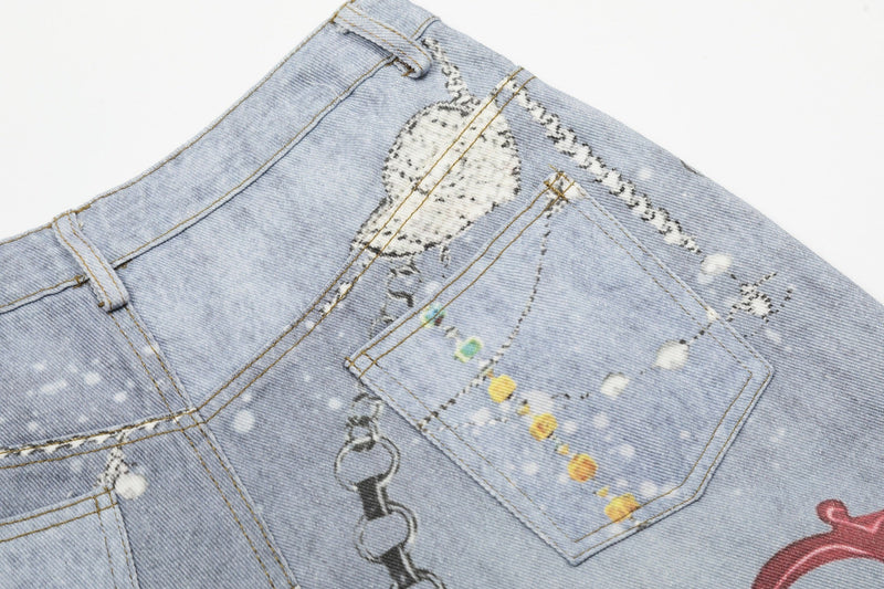 Close-up of back pocket on light wash denim shorts with chain graphic and white gem print