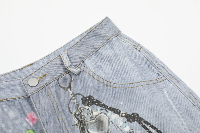 Close-up of front waistband and button on light wash denim shorts with chain print