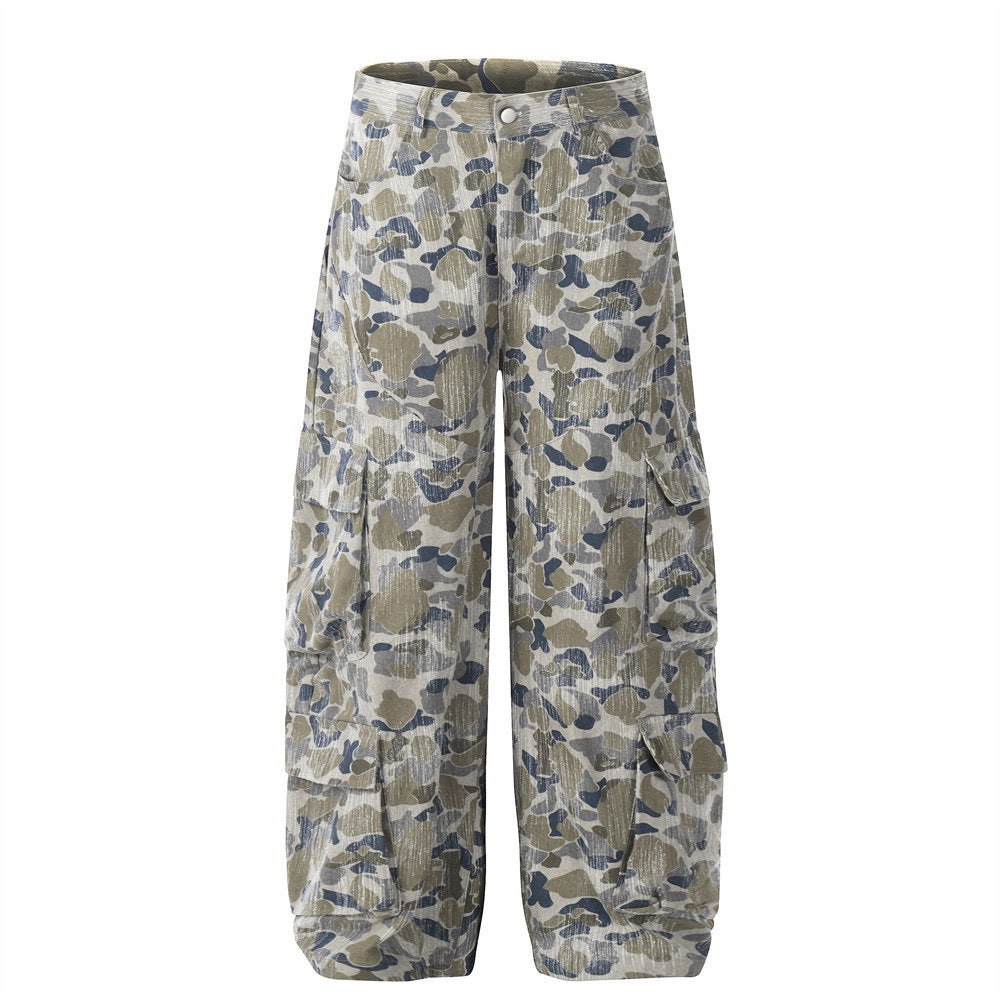 Front view of wide-leg camouflage corduroy cargo pants with flap pockets in olive, blue and cream tones