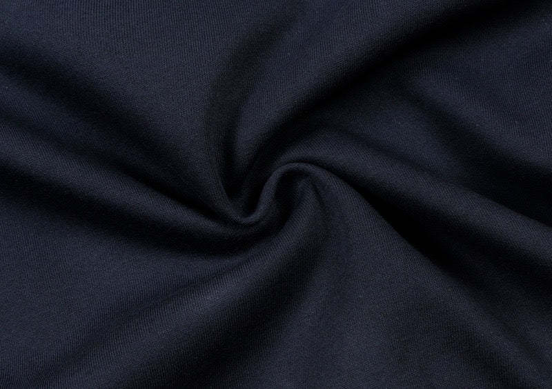 Close-up of dark navy sweatshirt fabric with soft twisted texture