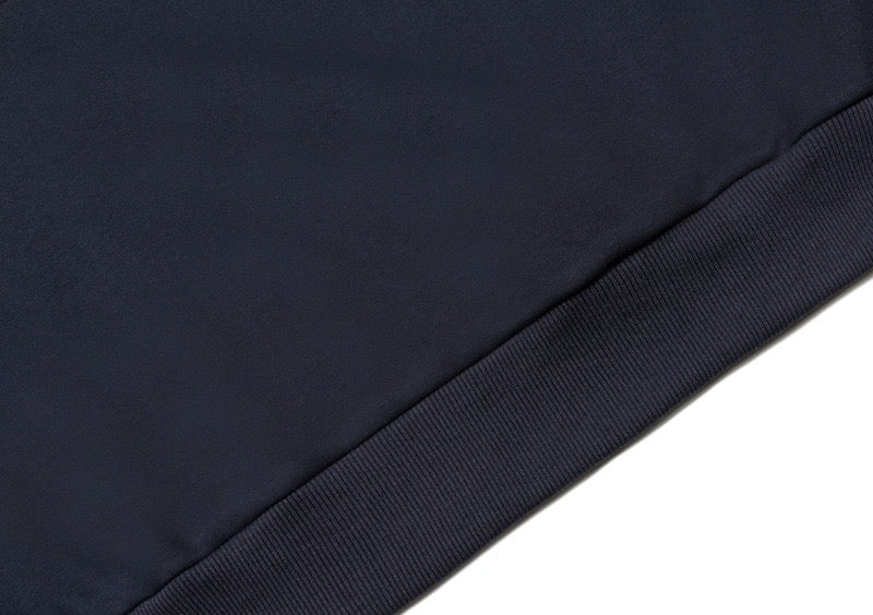 Close-up of a navy sweatshirt hem with ribbed trim