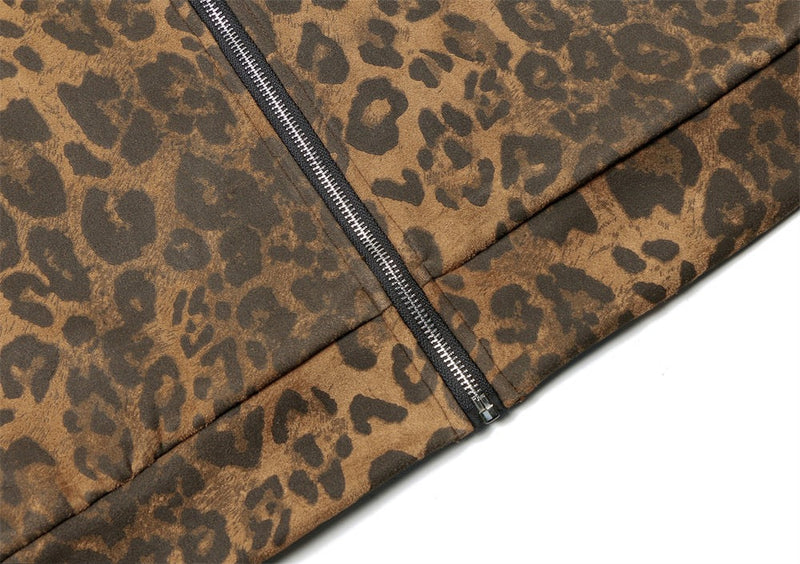Close-up of leopard print jacket hem with front zipper and satin-like fabric texture