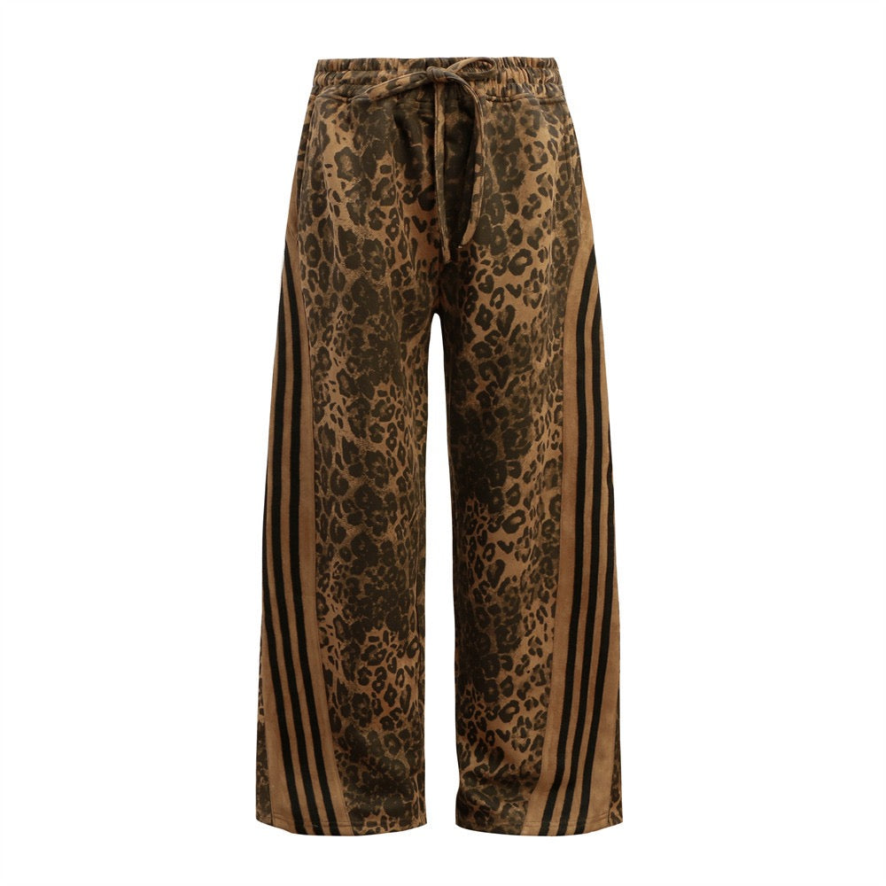 Front view of wide-leg leopard print pants with black athletic side stripes and elastic drawstring waistband